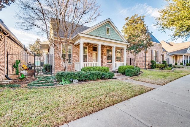 view of front of house with a front yard and covered porch