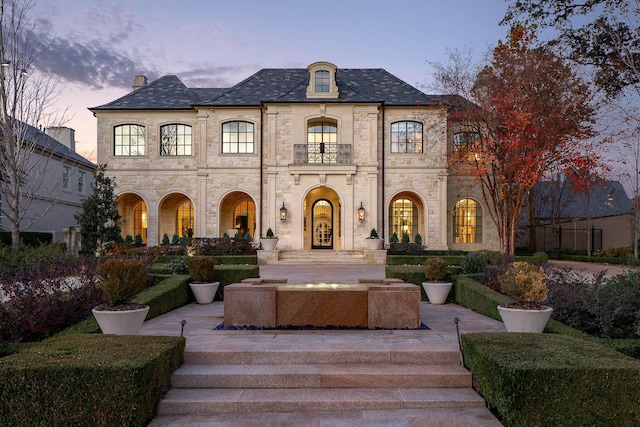 french country style house with a balcony