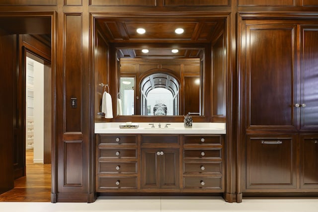 bathroom with vanity, wooden ceiling, and wooden walls