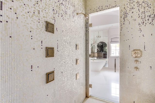 hallway featuring tile patterned flooring and tile walls