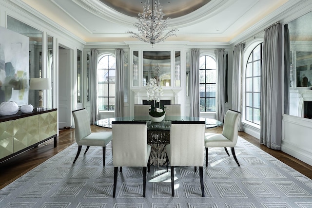 sunroom / solarium featuring a tray ceiling and an inviting chandelier