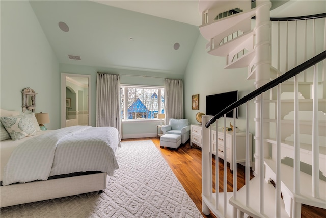 bedroom featuring lofted ceiling and hardwood / wood-style flooring