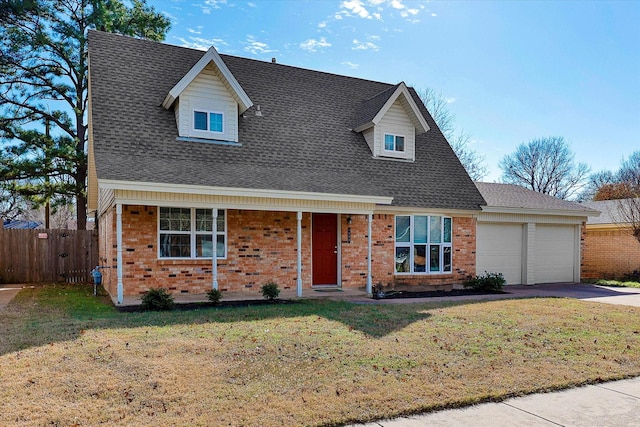 view of front of property with a garage and a front yard