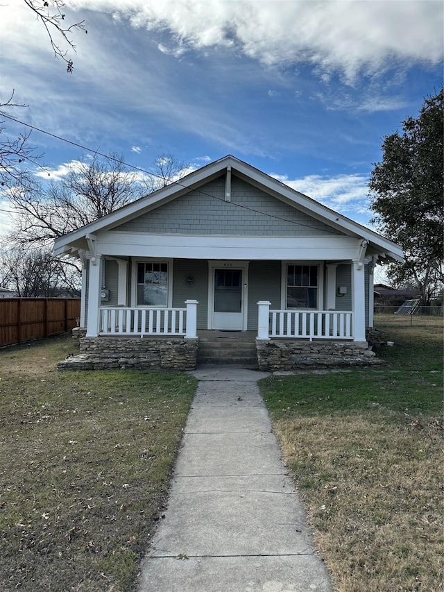 view of front of property with covered porch and a front lawn