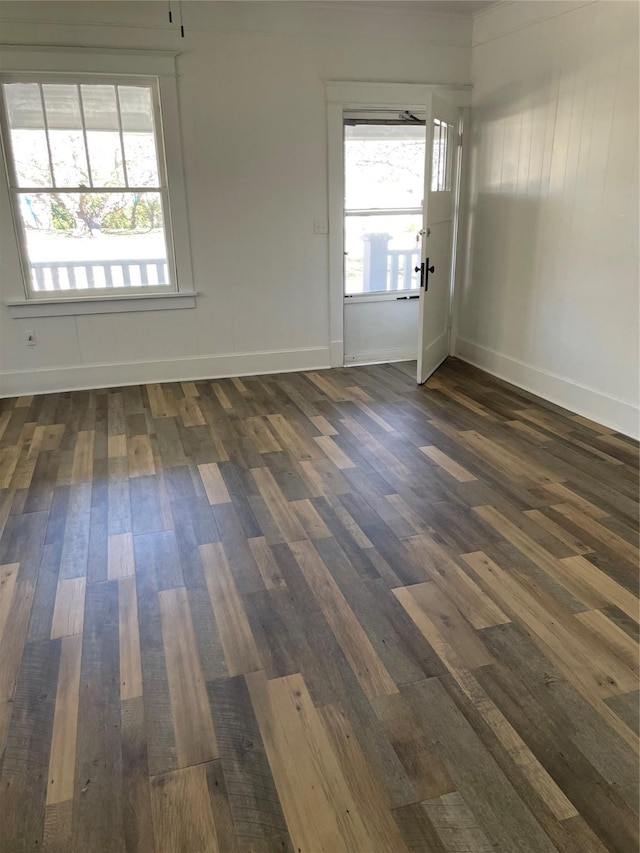 spare room with dark wood-type flooring