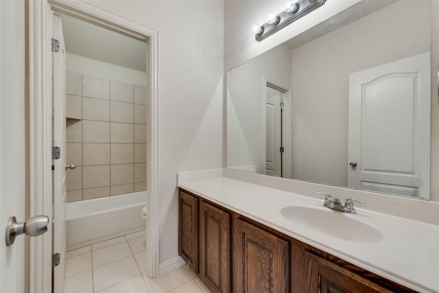 full bathroom featuring toilet, vanity, tiled shower / bath combo, and tile patterned floors