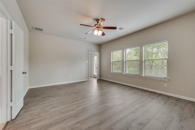 unfurnished room featuring light wood-type flooring and ceiling fan