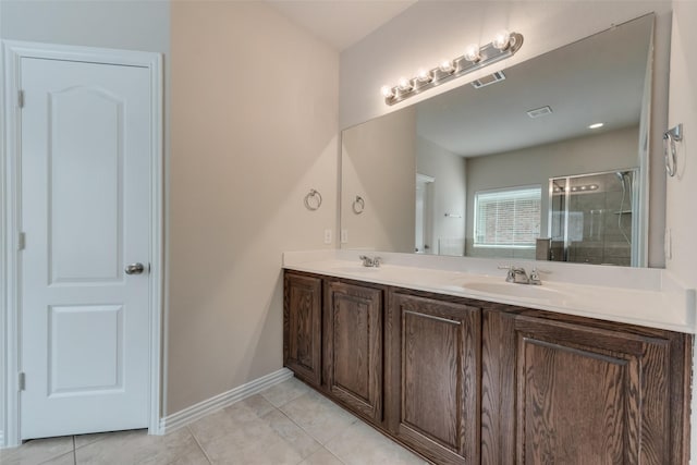 bathroom featuring tile patterned floors, an enclosed shower, and vanity