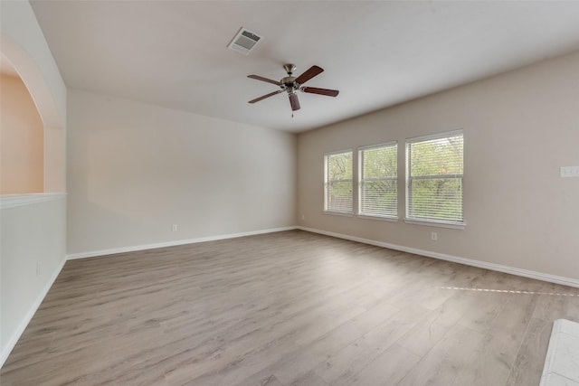 unfurnished room with ceiling fan and light wood-type flooring