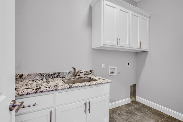 laundry area featuring hookup for a washing machine, hookup for an electric dryer, a sink, baseboards, and cabinet space