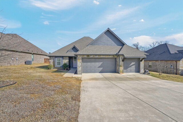 view of front of house with a garage and a front yard