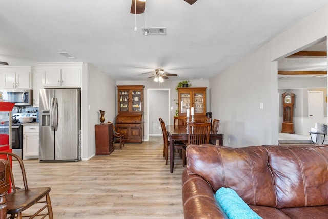 living room with ceiling fan and light wood-type flooring