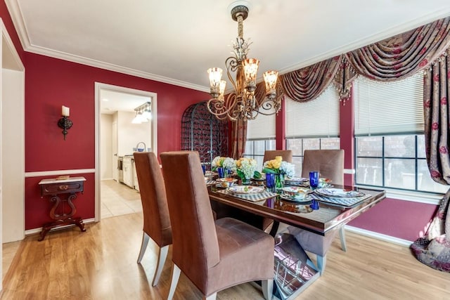 dining room with hardwood / wood-style flooring, crown molding, and a chandelier