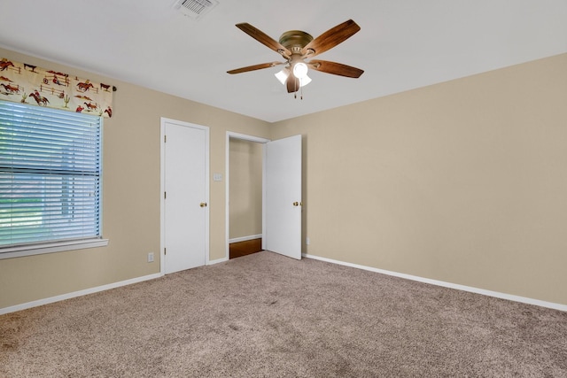 unfurnished bedroom with ceiling fan and carpet floors