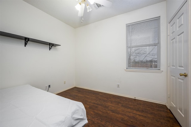 bedroom featuring ceiling fan and dark wood-type flooring