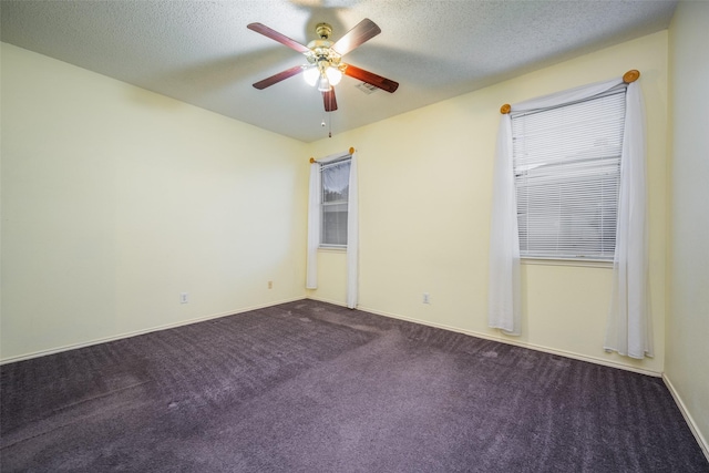 spare room featuring carpet floors, ceiling fan, and a textured ceiling