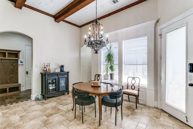 dining space with beam ceiling and a chandelier