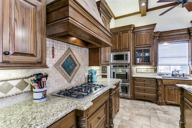 kitchen featuring backsplash, custom exhaust hood, beamed ceiling, light stone countertops, and stainless steel appliances