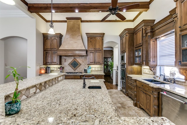 kitchen with tasteful backsplash, premium range hood, sink, beamed ceiling, and stainless steel appliances