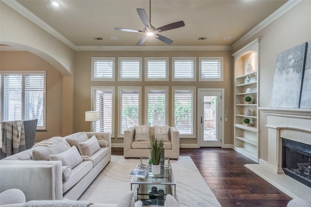 living room with ceiling fan and ornamental molding