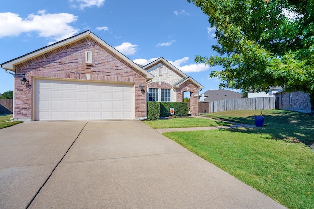 view of front of property featuring a garage and a front lawn