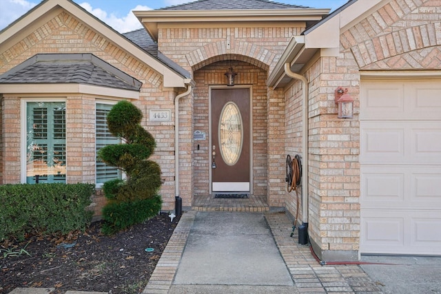 doorway to property with a garage