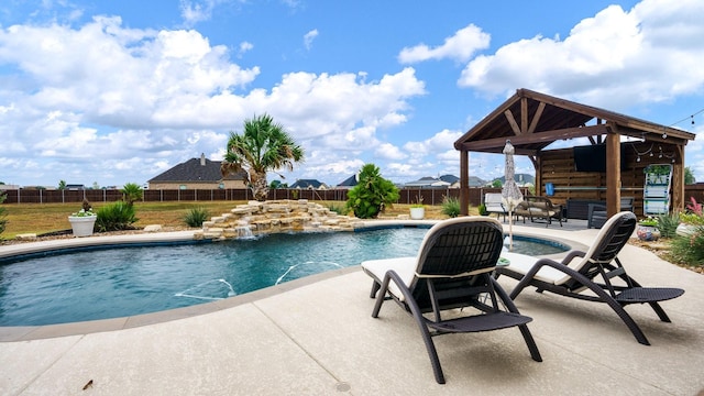 view of swimming pool with pool water feature, a gazebo, and a patio area