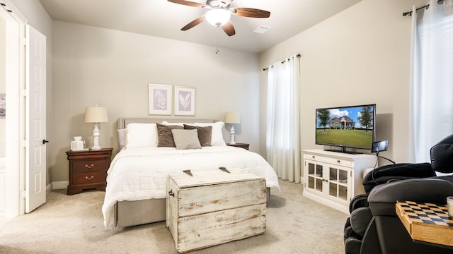 bedroom with ceiling fan and light carpet