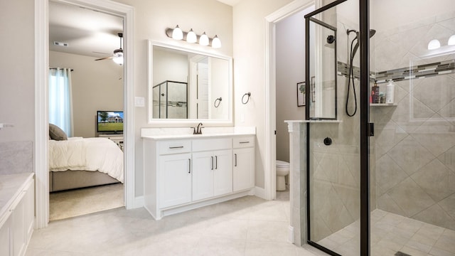 bathroom with toilet, vanity, ceiling fan, and an enclosed shower