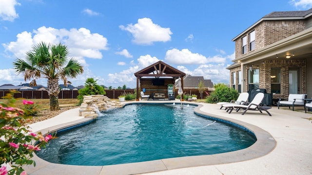 view of pool with pool water feature, a gazebo, and a patio area