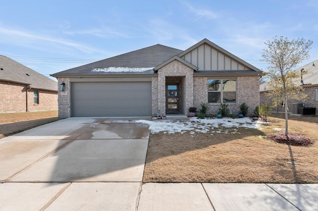 view of front of property with a garage and central AC