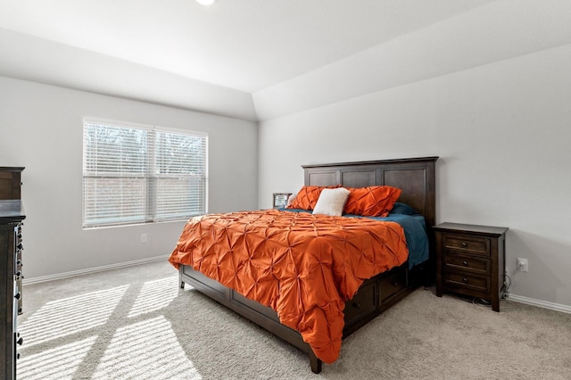 bedroom featuring light colored carpet and vaulted ceiling