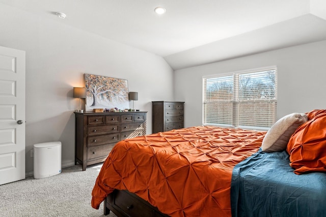 carpeted bedroom featuring lofted ceiling