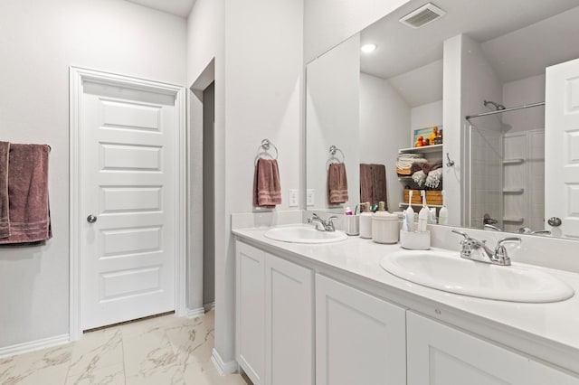 bathroom featuring walk in shower and vanity