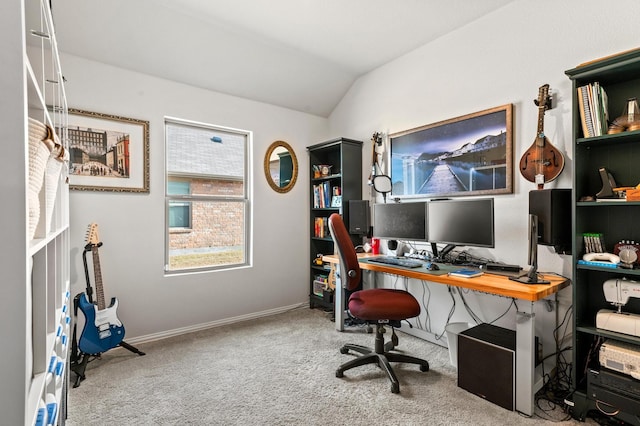 carpeted home office featuring vaulted ceiling