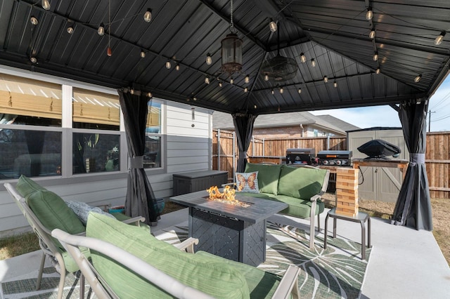 view of patio featuring an outdoor living space with a fire pit and a gazebo