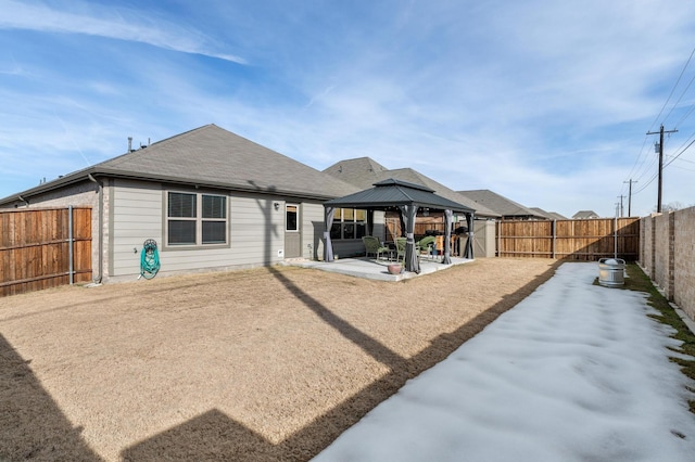 back of property with a gazebo and a patio