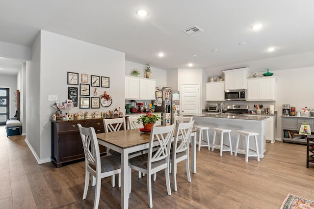 dining space featuring light hardwood / wood-style flooring