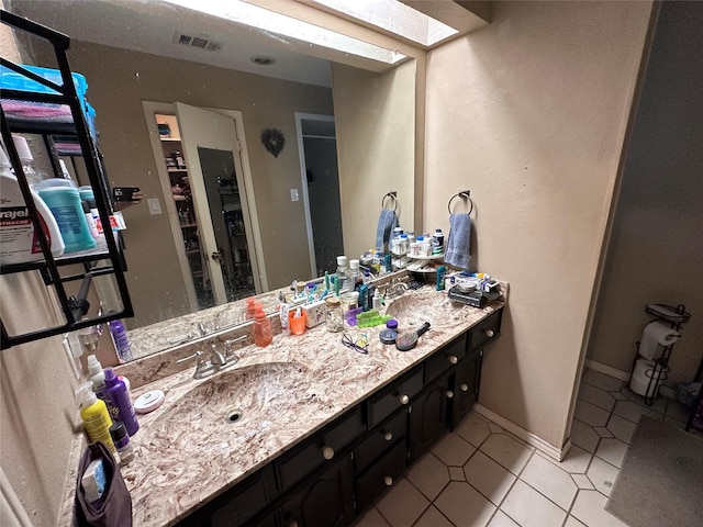 bathroom with tile patterned flooring and vanity