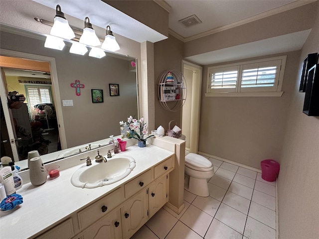 bathroom with toilet, vanity, tile patterned flooring, and ornamental molding