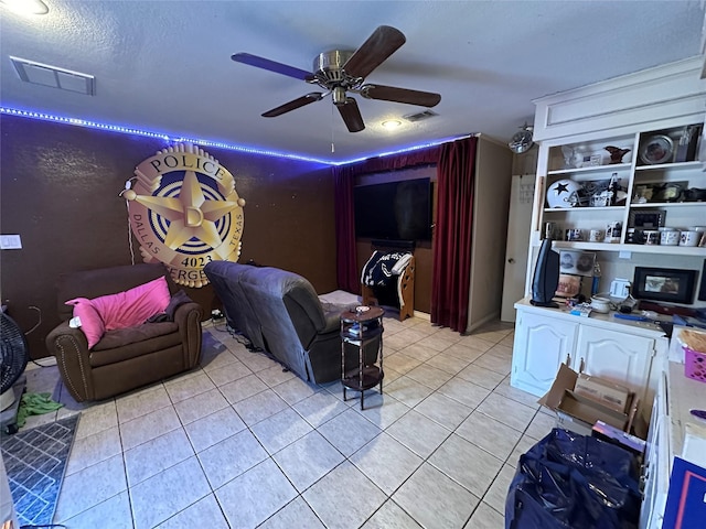 interior space featuring ceiling fan and a textured ceiling