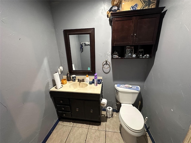 bathroom featuring tile patterned floors, vanity, and toilet