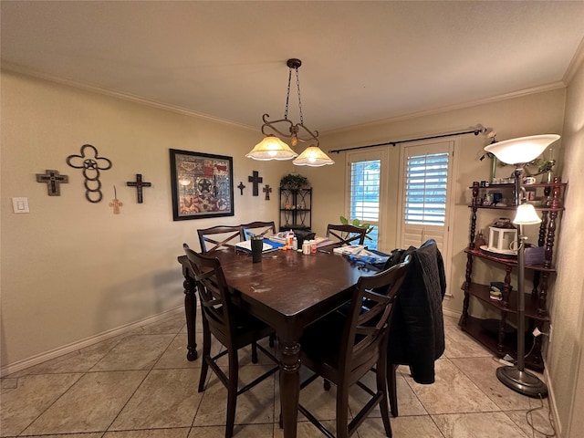 tiled dining room featuring crown molding