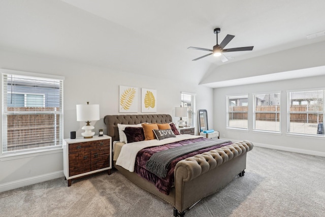 carpeted bedroom featuring vaulted ceiling, multiple windows, a ceiling fan, and baseboards