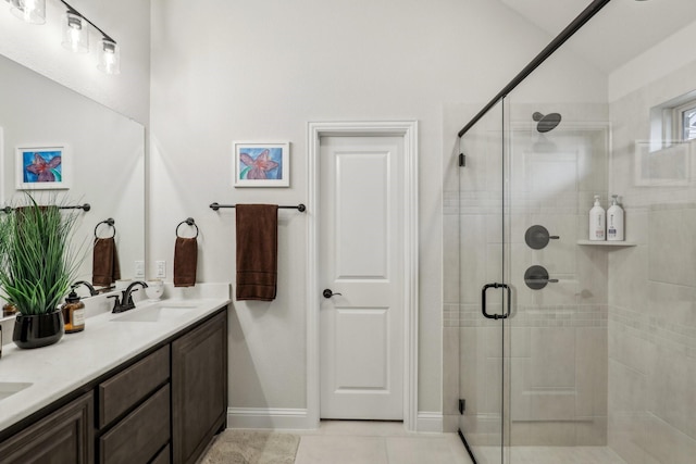 bathroom with vanity, tile patterned flooring, and a shower with door