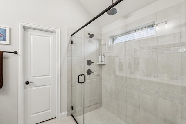 bathroom featuring a shower with shower door