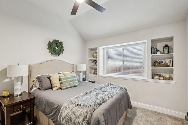 carpeted bedroom featuring lofted ceiling, baseboards, and a ceiling fan