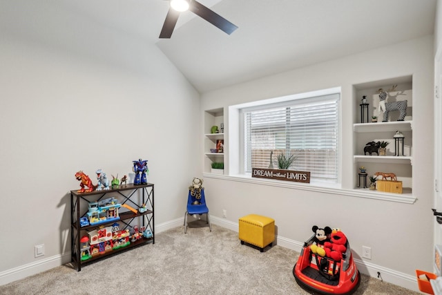 playroom featuring vaulted ceiling, ceiling fan, carpet, and built in features