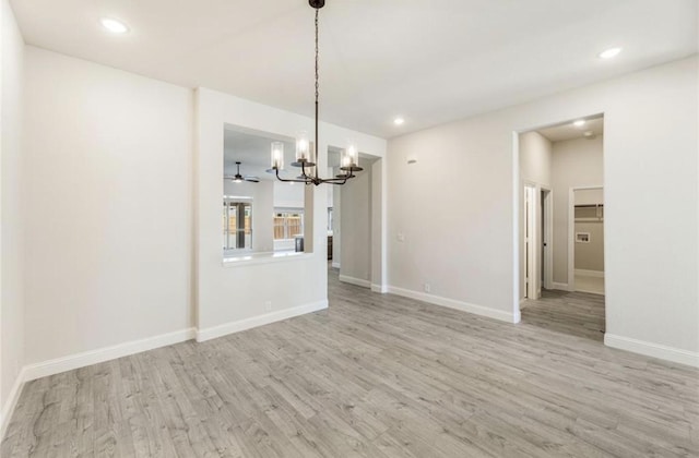 unfurnished dining area featuring light hardwood / wood-style floors and a chandelier