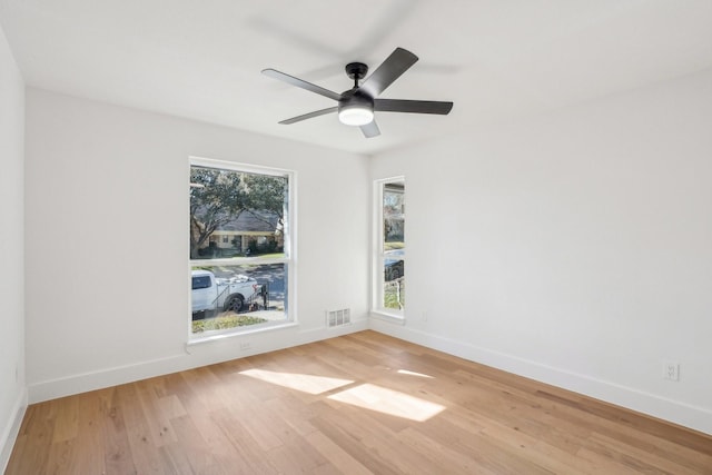 unfurnished room with ceiling fan and hardwood / wood-style flooring